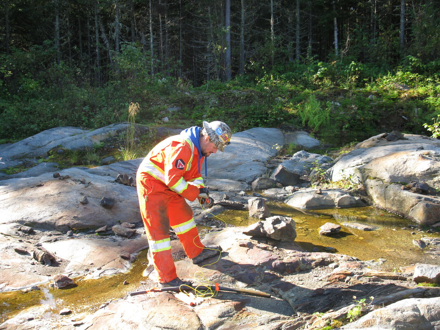 Geologist sampling a creek